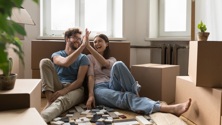 Happy couple with moving boxes