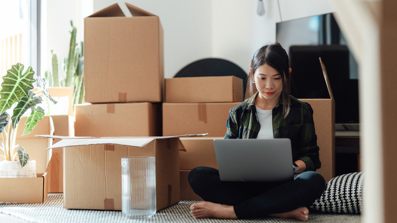 Woman sitting with moving boxes