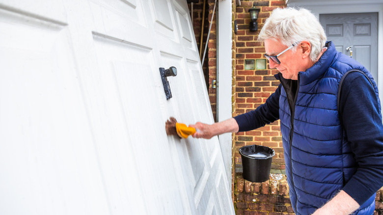 Man cleaning the outside of garage door