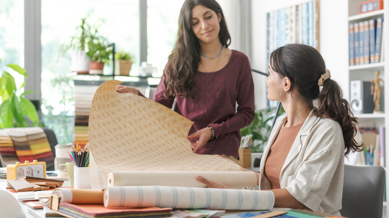 Interior designer women comparing patterned upholstery