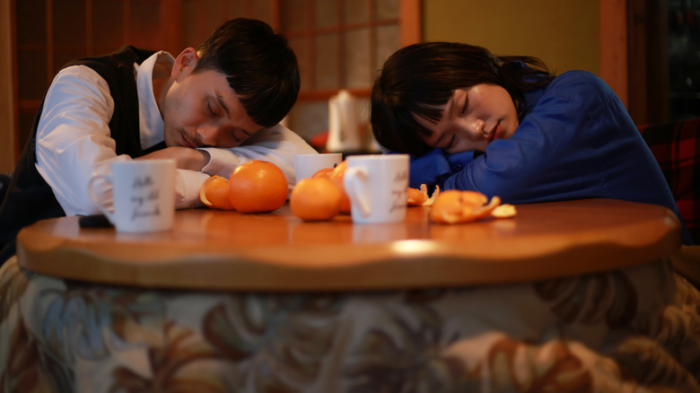 Couple sleeping at a kotatsu