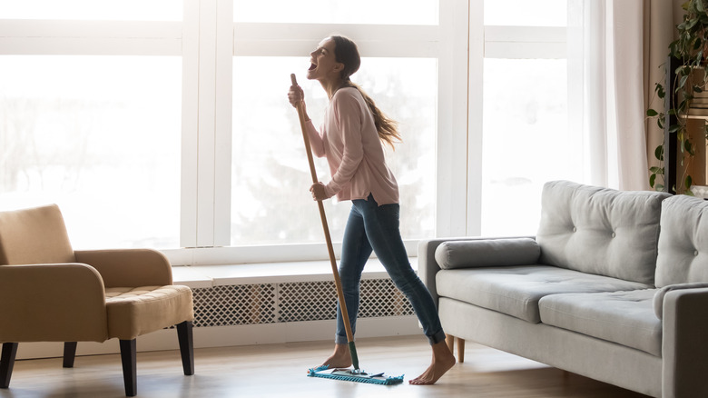 woman singing with mop