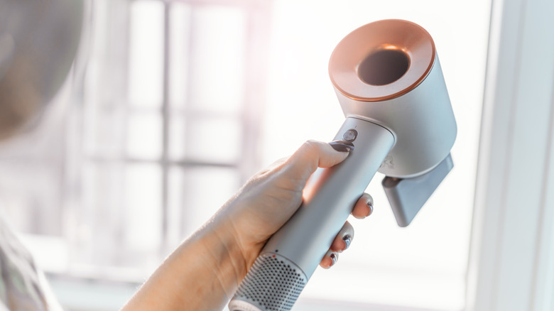 Woman holding blow dryer 