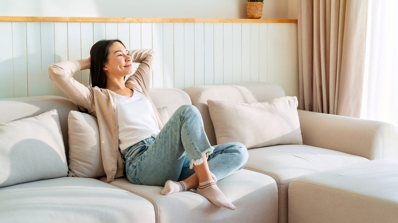 woman relaxing on couch being lazy