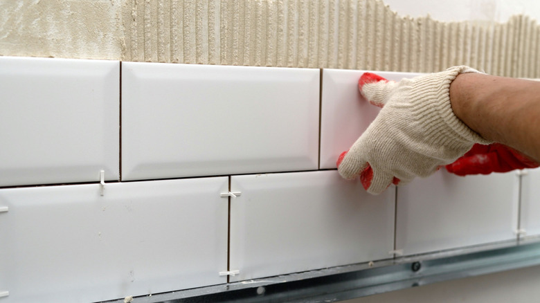 Tiling a kitchen backsplash.