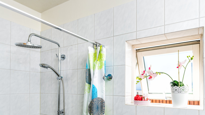 Shower curtain rod anchored to bathroom tile wall