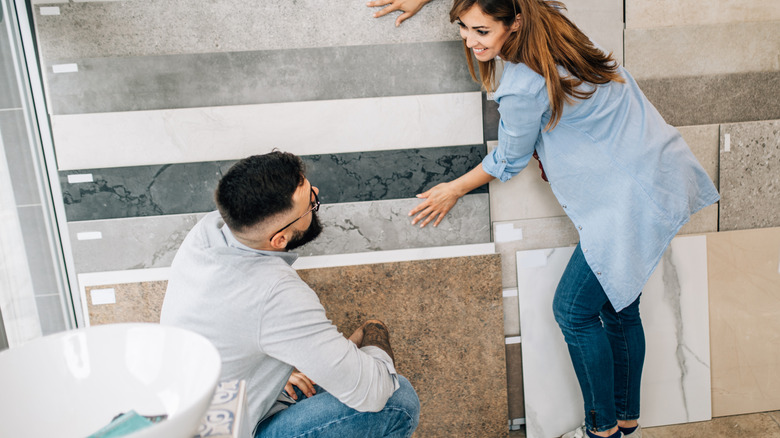 Couple choosing bathroom tiles in a store