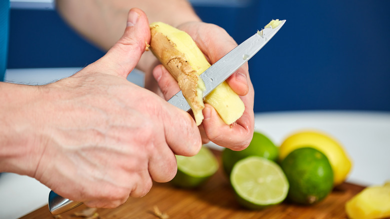 Person cutting ginger root