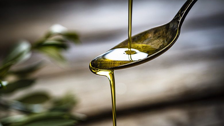 pouring oil onto a spoon