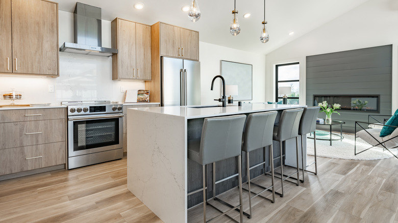 Modern kitchen with a waterfall edge island countertop