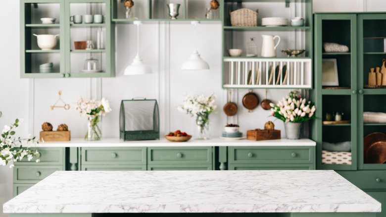 green kitchen with white marble