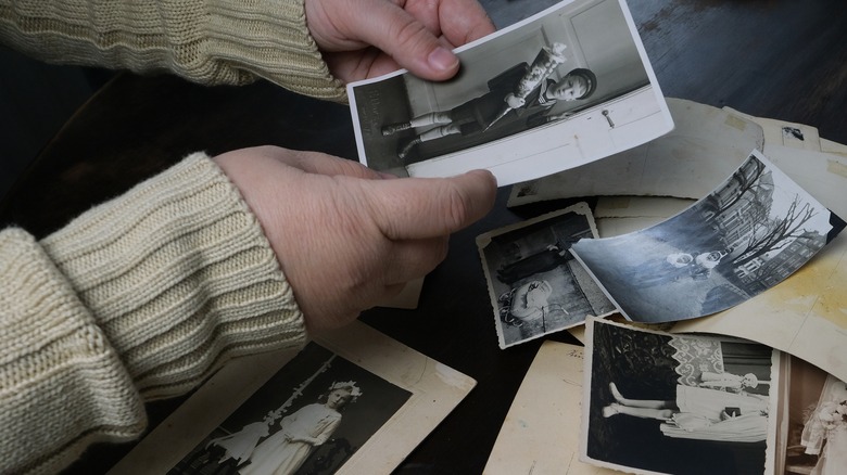 person handling vintage photos