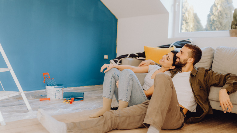 couple smiling in painted room