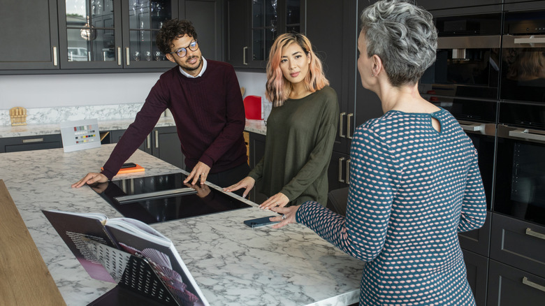 A couple designing their kitchen with an interior designer