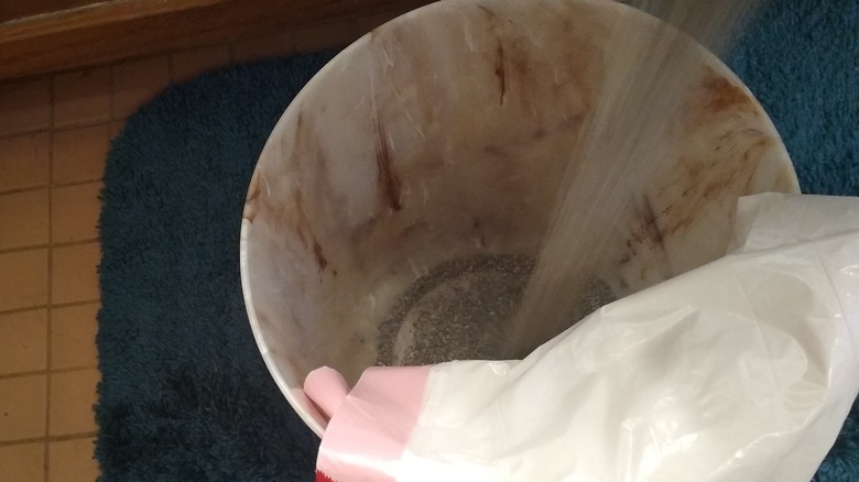 kitty litter in garbage can