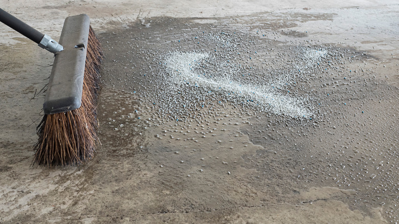 Sweeping litter onto garage stain