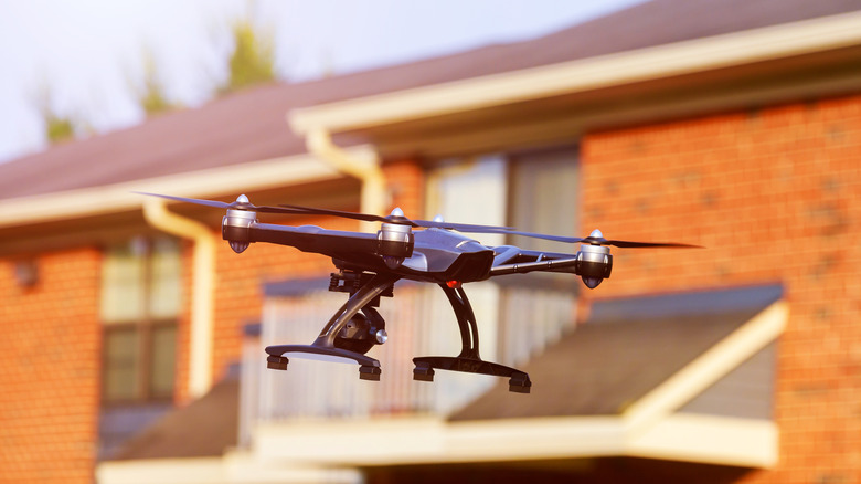 A drone hovering over a house