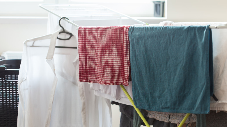 Wet laundry air drying on rack inside