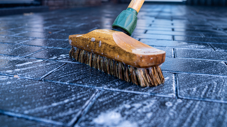 brush scrubbing stone driveway