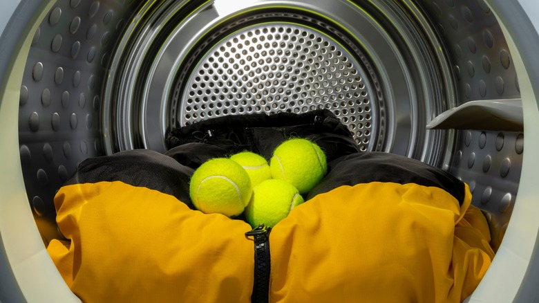 Tennis balls and coat in dryer