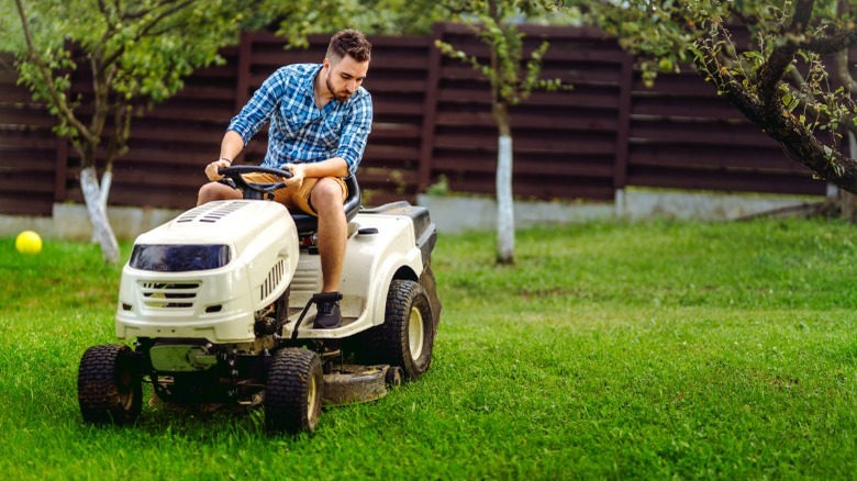 Man using a riding lawnmower 