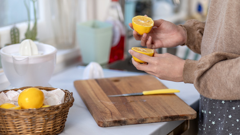 Someone cutting lemons