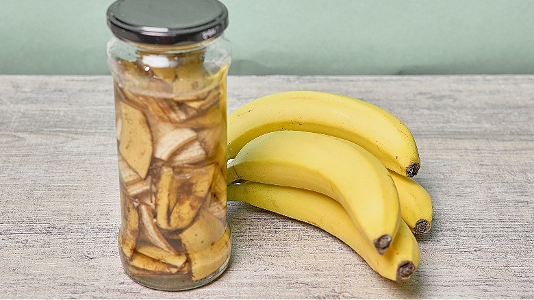 Jar with banana peel, water