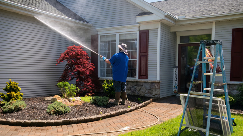 Someone using an electric power washer