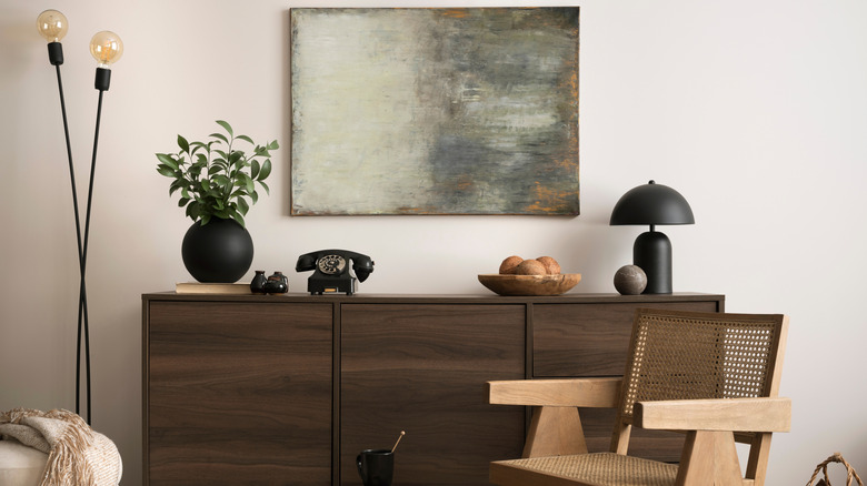 Brown table with modern black lamp and floor lamp with exposed lightbulbs