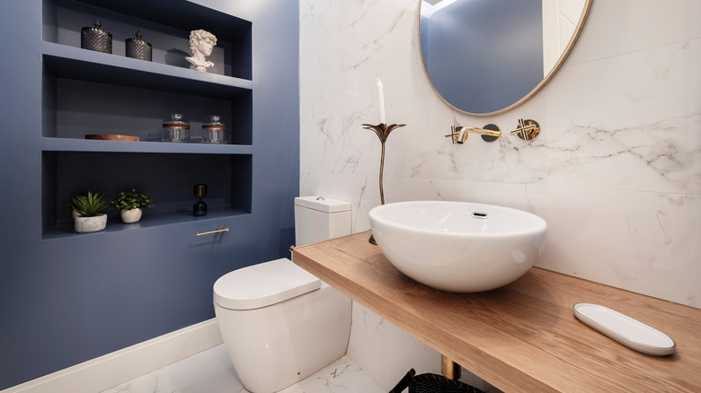 stylish half bath with marble tile