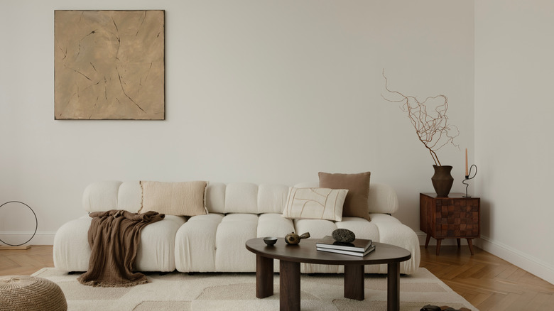 Single large painting above sofa in living room