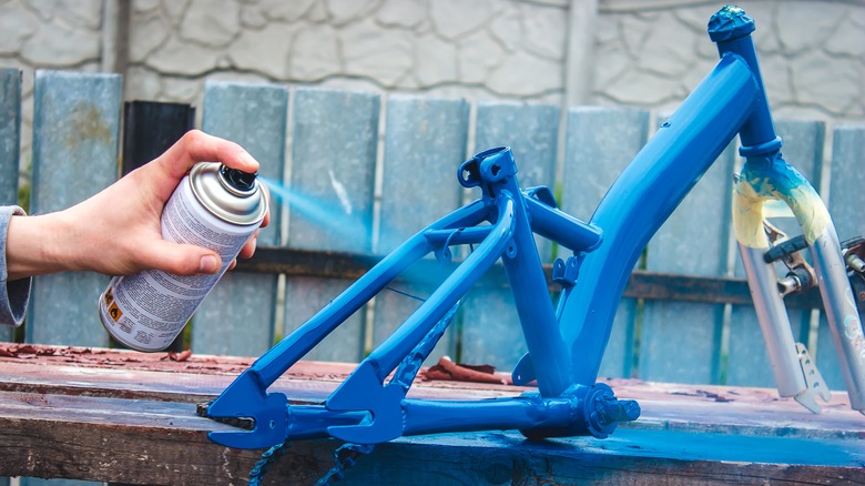 spray painting a bicycle frame
