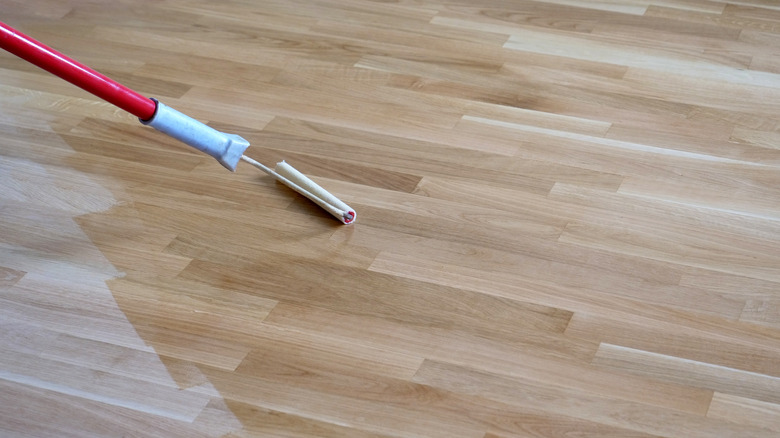 Wood floor with shiny finish layer