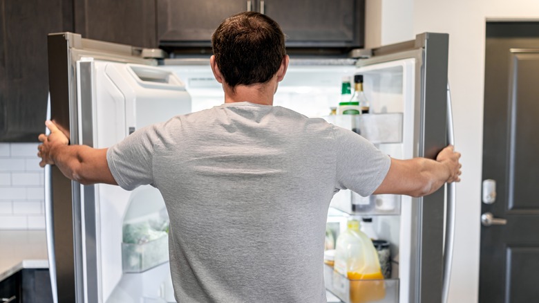 Man looking in fridge 