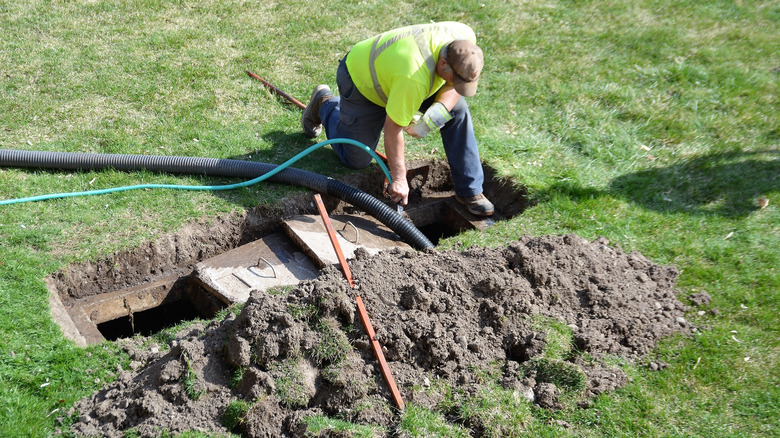 worker with septic tank