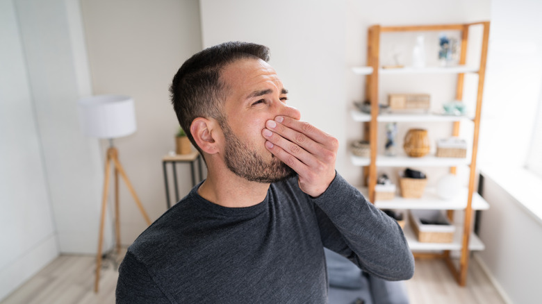 Man holding nose