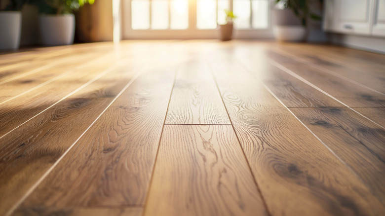 Clean linoleum wood-look flooring with sunny window in the background