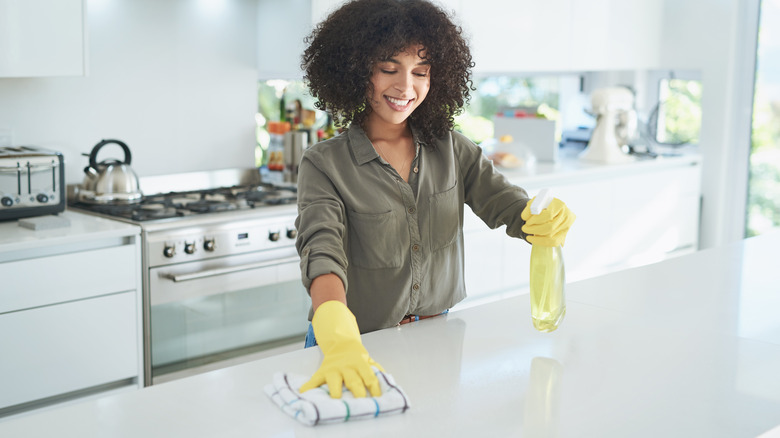 Woman cleaning kitchen counter