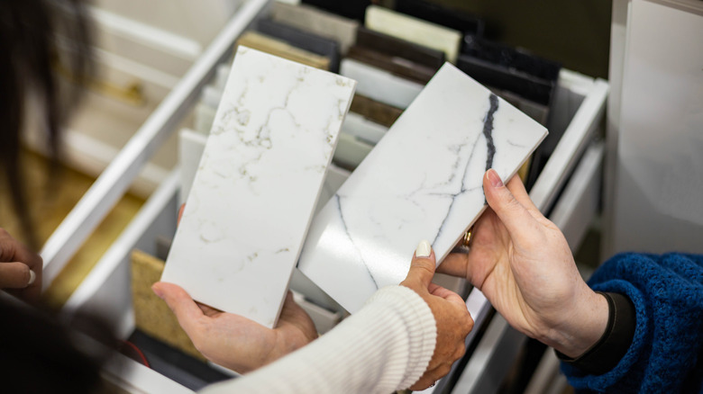 People examining samples of marble