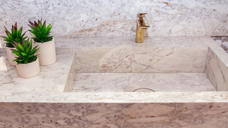 Kitchen countertop, backsplash, and sink made of marble