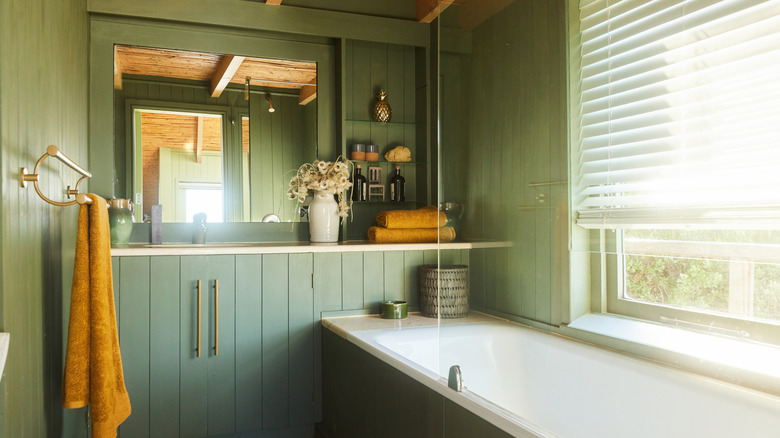 wood and sage green themed bathroom design