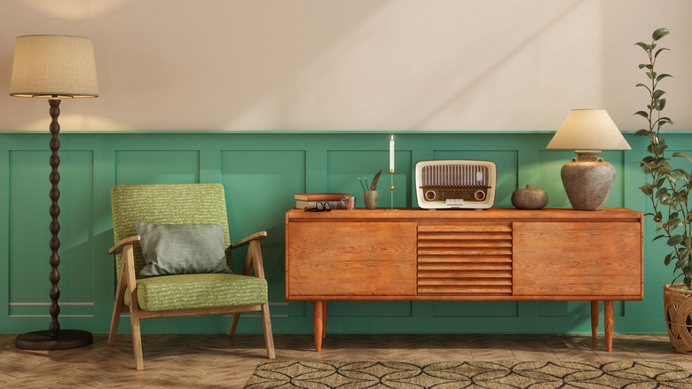 Vintage green chair and credenza with candle and radio