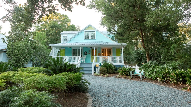 Blue house with a gravel driveway