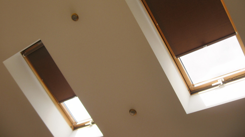 Skylights with brown roller blinds to control light and heat