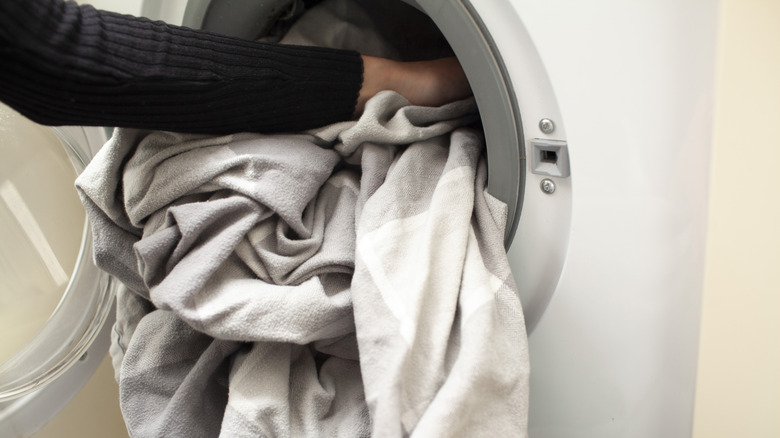 Cramming sheets into washing machine