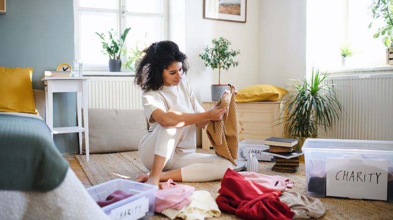 woman folding clothing items