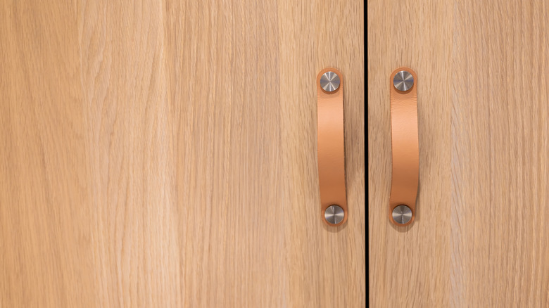 Unique soft handles on a pair of wood doors