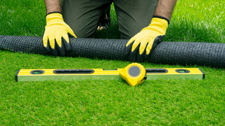 Person installing turf grass