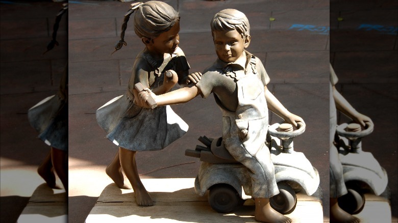 Garden statue of children playing