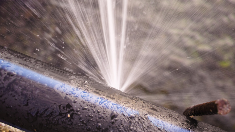 burst pipe with water spurting